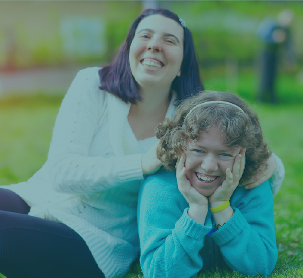 Two people laying in the grass, laughing